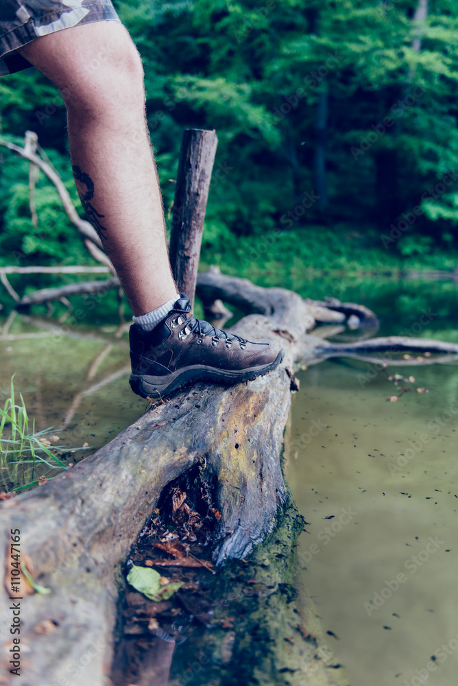 Picture of man shoes standing on a tree log Picture of man shoes standing on a tree log