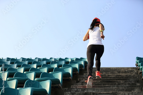 Obraz na plátně young fitness woman runner athlete running up on stairs.
