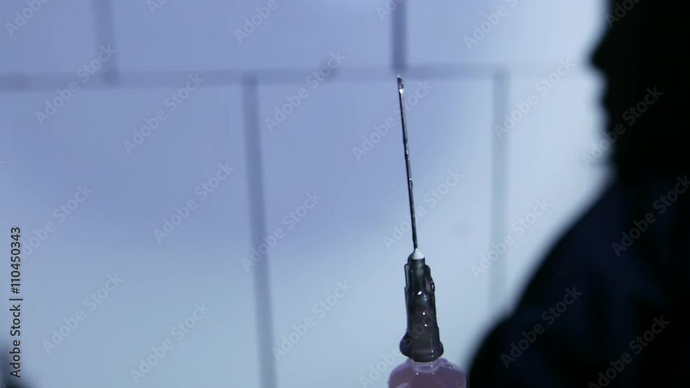 Close-up liquid substance in syringe, drug injection, narcotics. 4K UHD. Close-up liquid substance in syringe, drug injection, narcotics. 4K UHD.