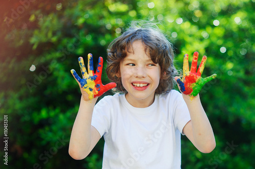Young boy smile and show his colorful hands