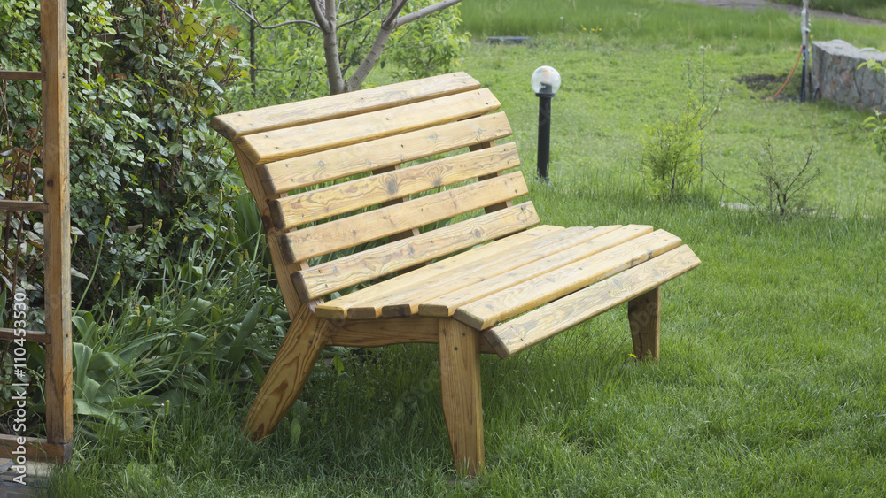 lacquered wooden garden bench on the lawn lacquered wooden garden bench on the lawn