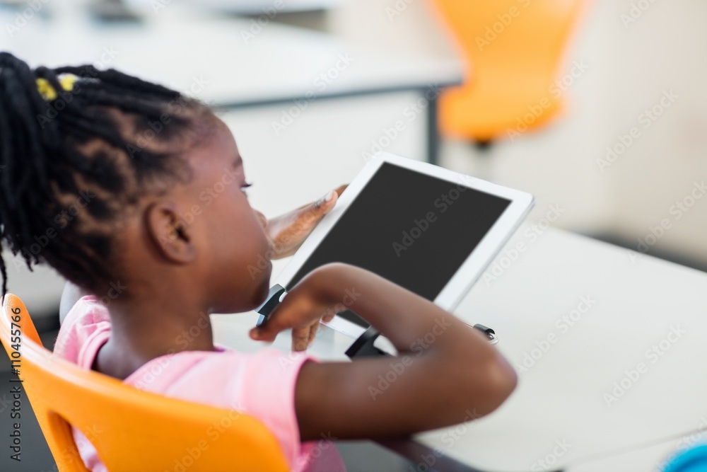 Side view of pupil using tablet pc in classroom Side view of pupil using tablet pc in classroom