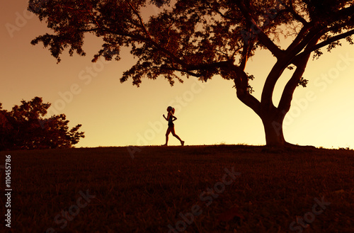 silhouette of women runner running in a beautiful outdoor setting. 