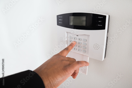 Businesswoman Hand Entering Code In Security System