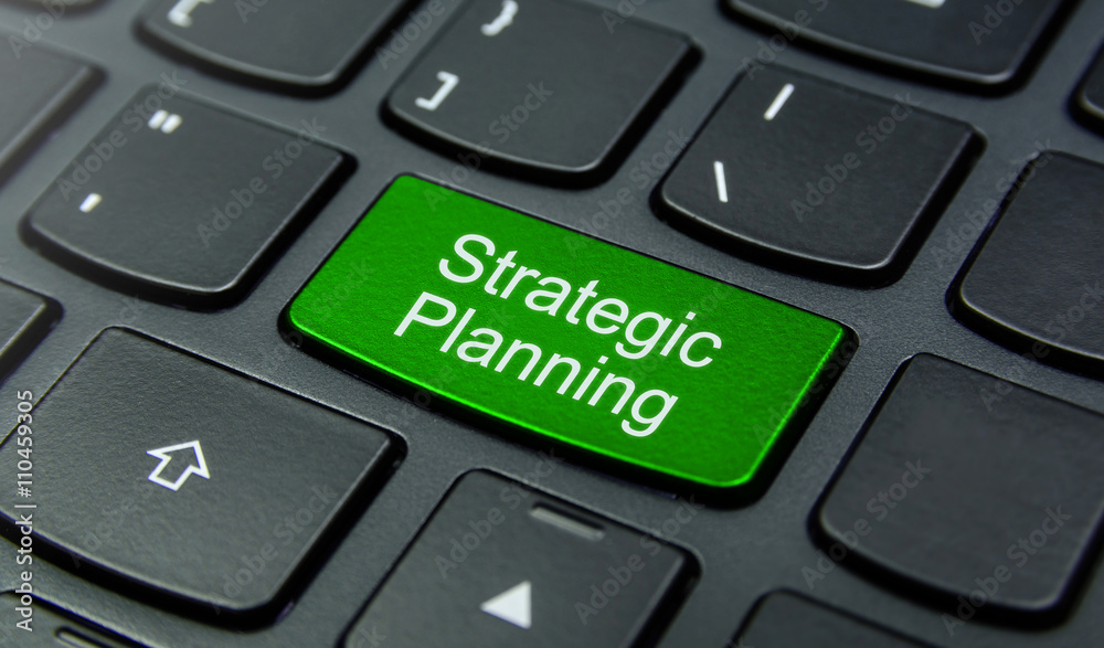 Business Concept: Close-up the Strategic Planning button on the keyboard and have Lime, Green color button isolate black keyboard Business Concept: Close-up the Strategic Planning button on the keyboard and have Lime, Green color button isolate black keyboard