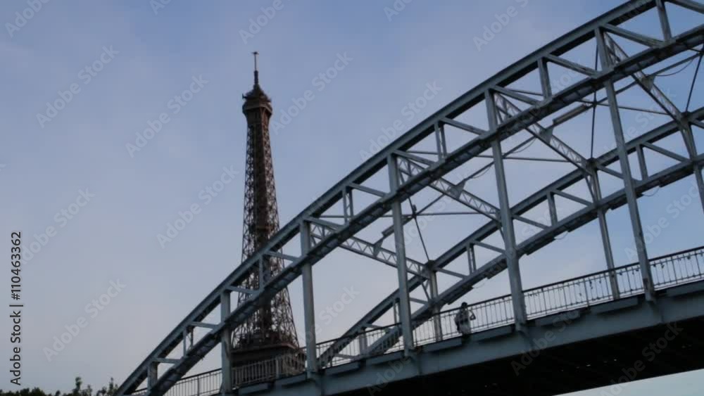 FRANCE, PARIS - JUNE 8, 2015: Top of famous Eiffel Tower from boat on river FRANCE, PARIS - JUNE 8, 2015: Top of famous Eiffel Tower from boat on river