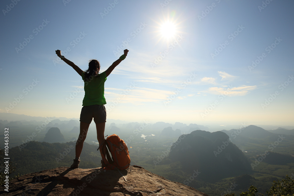 cheering woman hiker open arms at sunrise mountain peak cheering woman hiker open arms at sunrise mountain peak