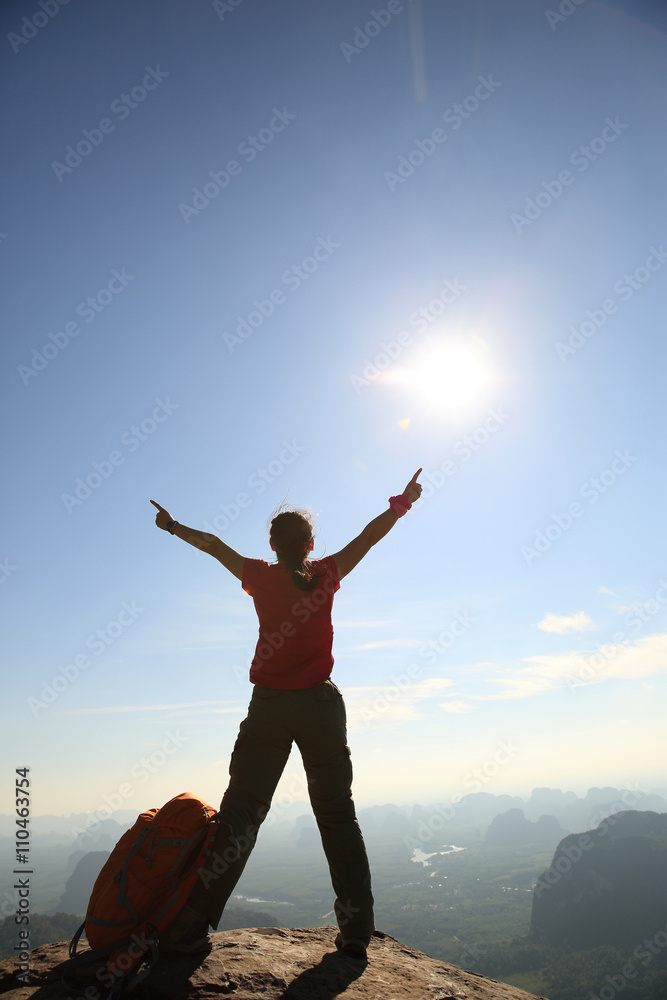 cheering woman hiker open arms at sunrise mountain peak cheering woman hiker open arms at sunrise mountain peak