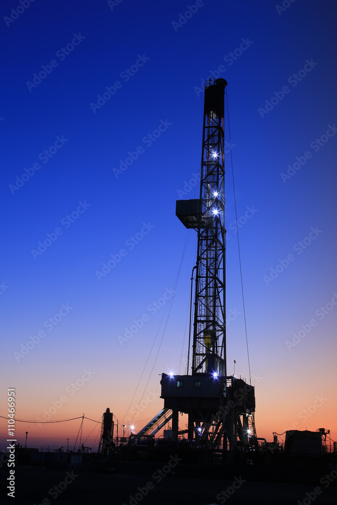 In the evening of oilfield derrick