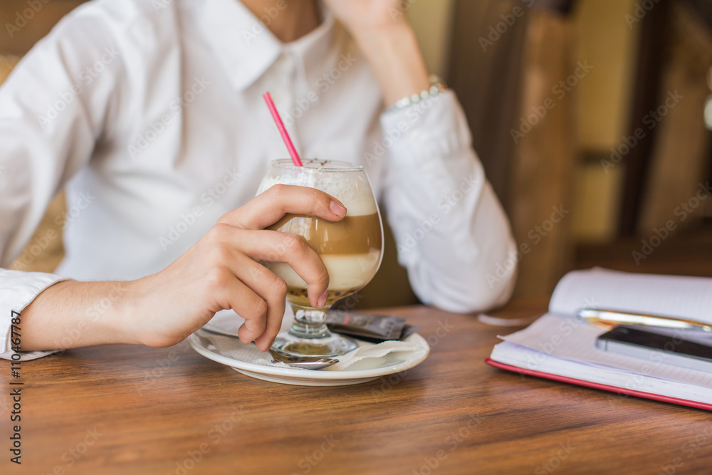 Business  woman drinking latte coffee in restaurant.
