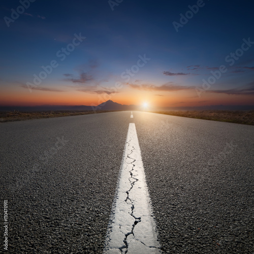 Driving on open road towards the mountain at sunrise © rasica