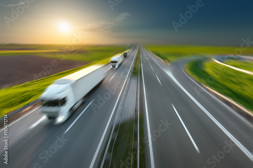 Motion image of modern delivery trucks on the highway