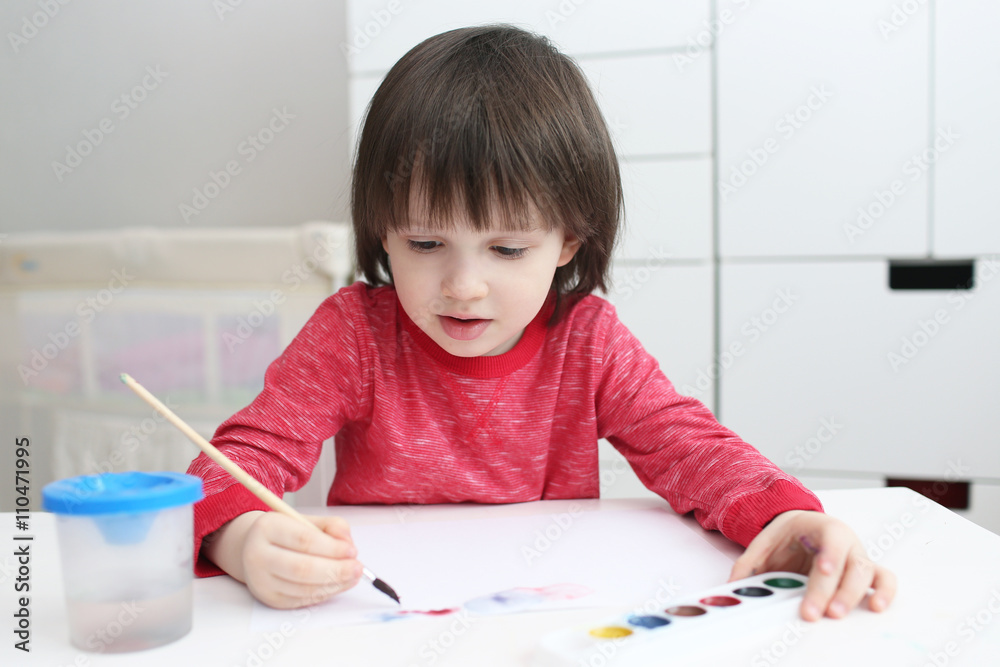 Little boy is painting with watercolor at home Little boy is painting with watercolor at home