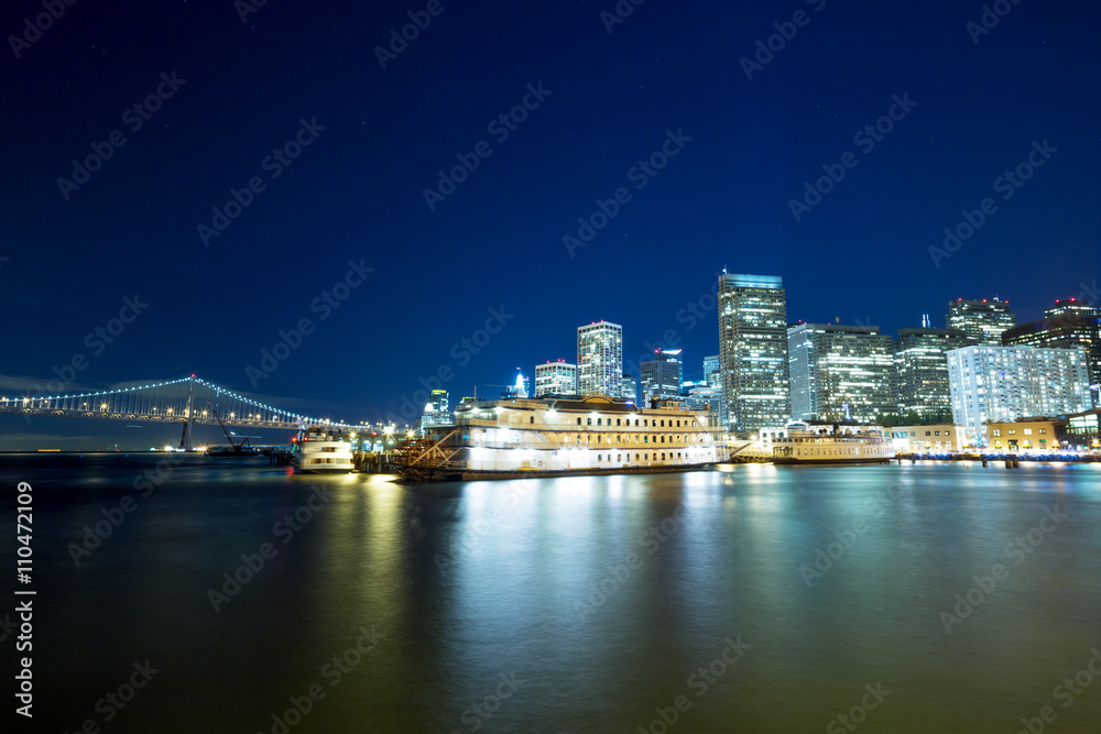 passenger liner on tranquil water with cityscape and skyline of