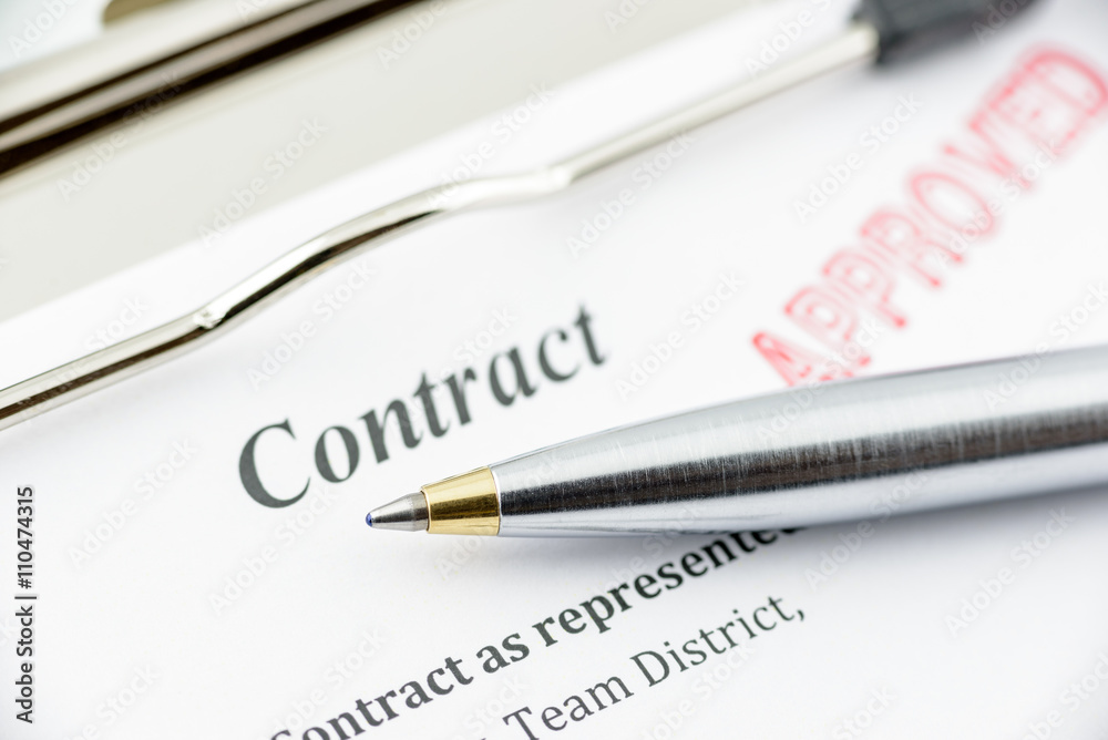 Blue ballpoint pen on an approved contract. Blue ballpoint pen on an approved contract.