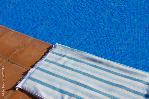 towel and bathing accessories near pool photo