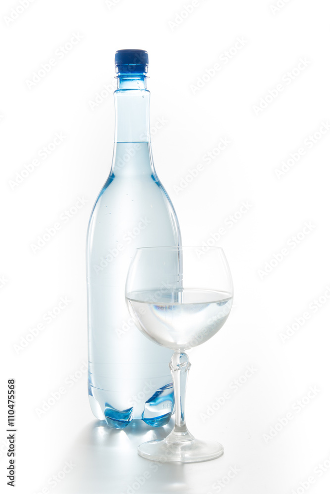 Glass of water with a bottle isolated on white Glass of water with a bottle isolated on white