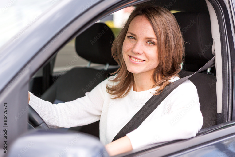 Young attractive woman driving his car