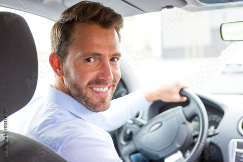 Young attractive man driving his car