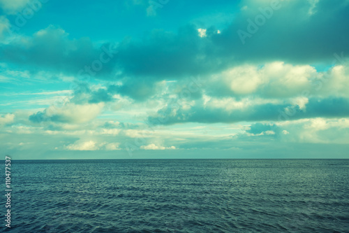Sea with cloudy sky. Blue toned