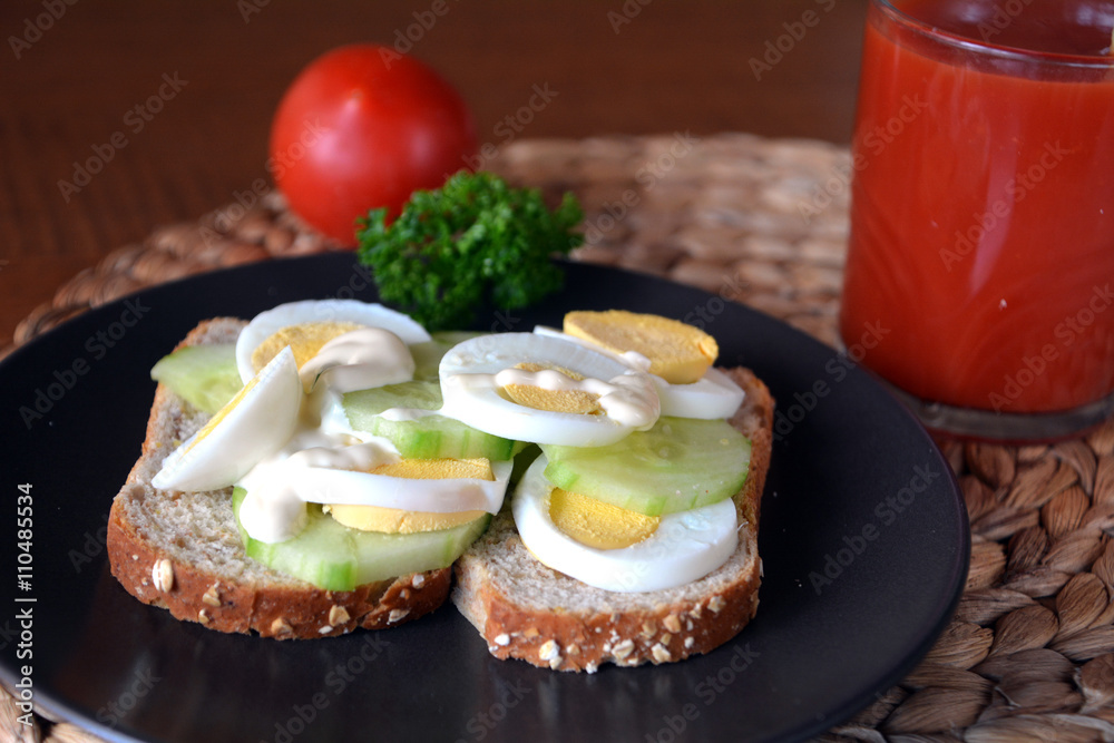 Healthy fresh homemade sandwich with eggs and cucumber with tomato smoothie