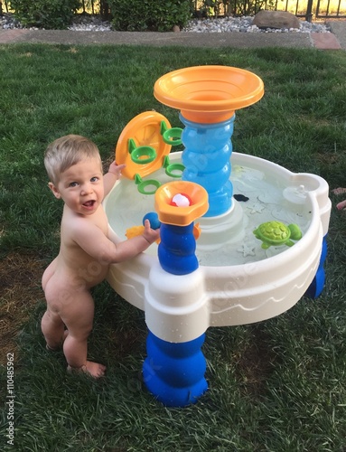 Baby Toddler Playing Outsie With Water Table photo