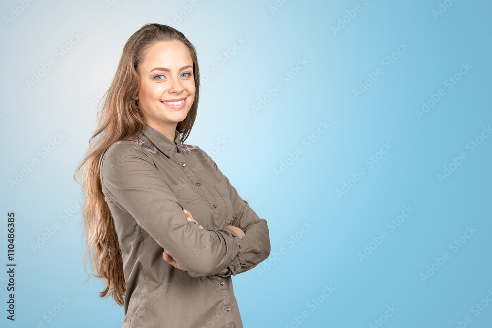 Woman with crossed arms standing adn smiling Woman with crossed arms standing adn smiling