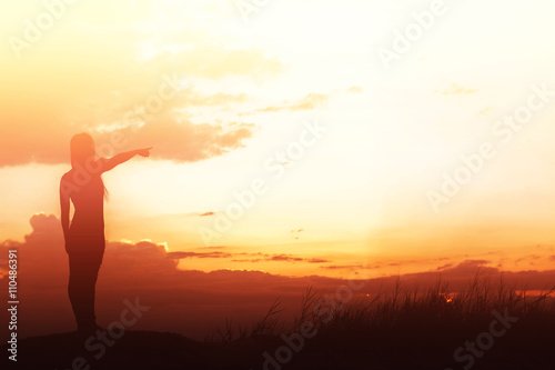 woman standing alone at the field during beautiful sunset © Johnstocker