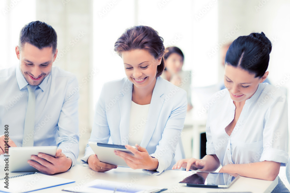 business team working with tablet pcs in office business team working with tablet pcs in office