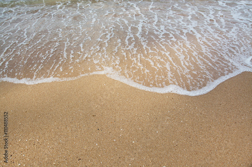 Sea waves and sandy beach background