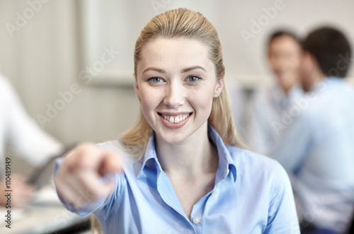 smiling businesswoman pointing finger on you
