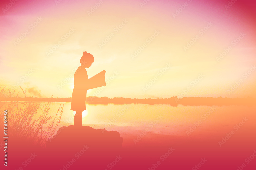 silhouette children reading book time at sunset