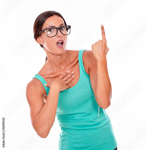 Surprised woman pointing at copy space