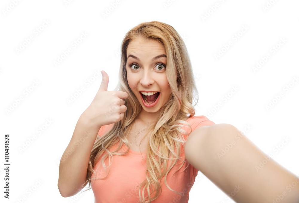 happy woman taking selfie and showing thumbs up happy woman taking selfie and showing thumbs up