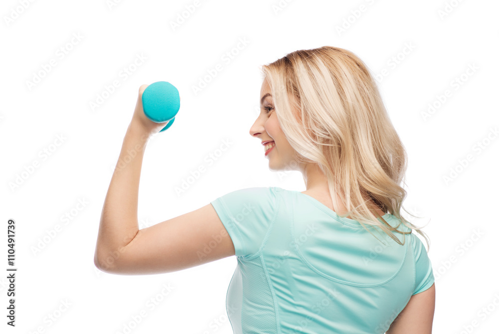smiling beautiful young sporty woman with dumbbell