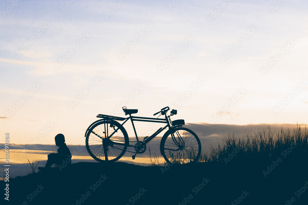 Fototapeta premium little boy sitting with bike