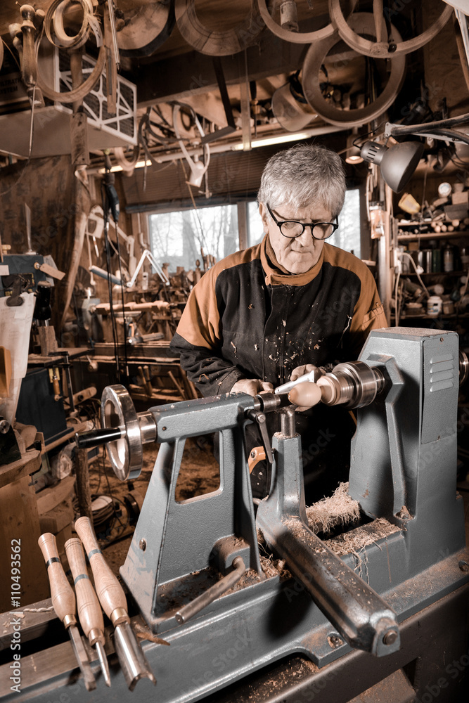 Woodturners using a rotating clamp to turn the wood. Woodturners using a rotating clamp to turn the wood.