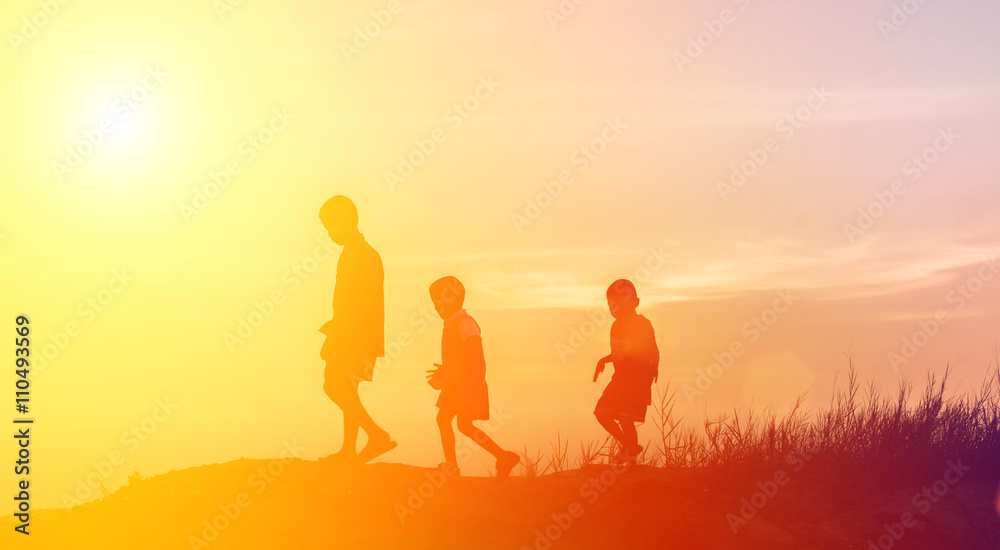 silhouette children playing happy time at sunset
