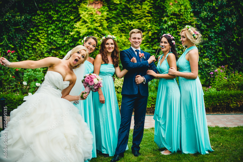 Bridesmaids, groom and his funny wife