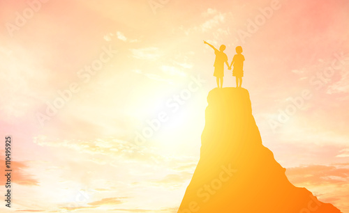 Silhouette boy and girl pointing to the future. © Johnstocker