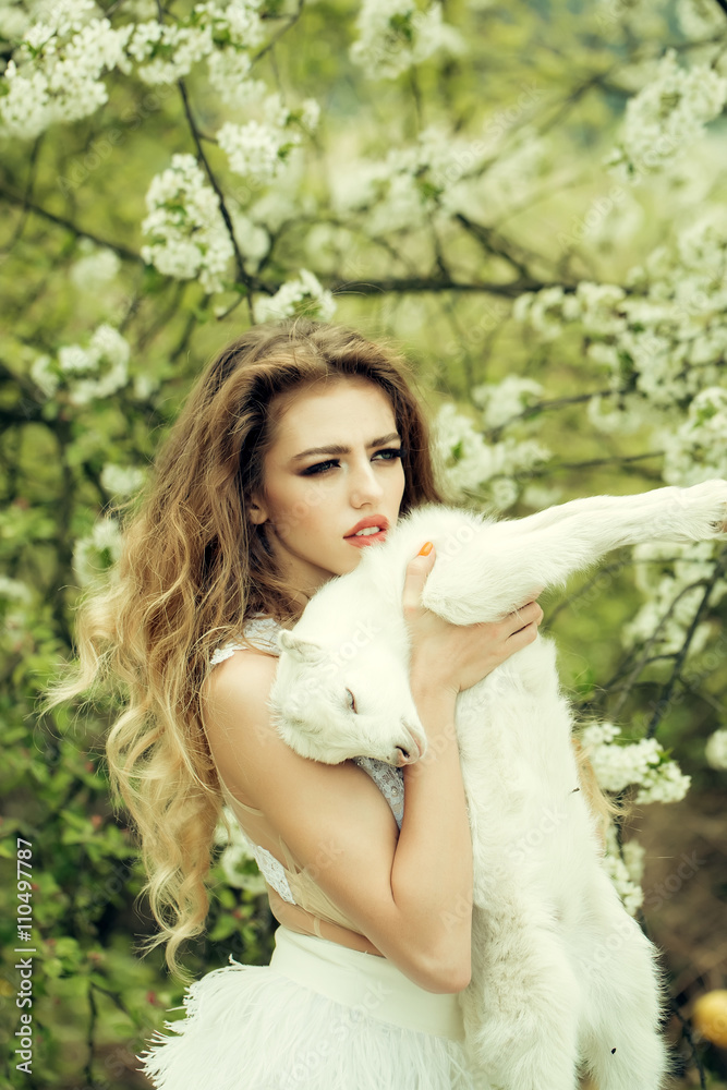 Woman with goat in blossom