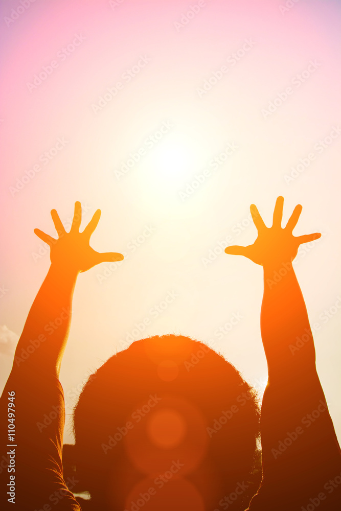 Silhouette man show his hands up to the winner