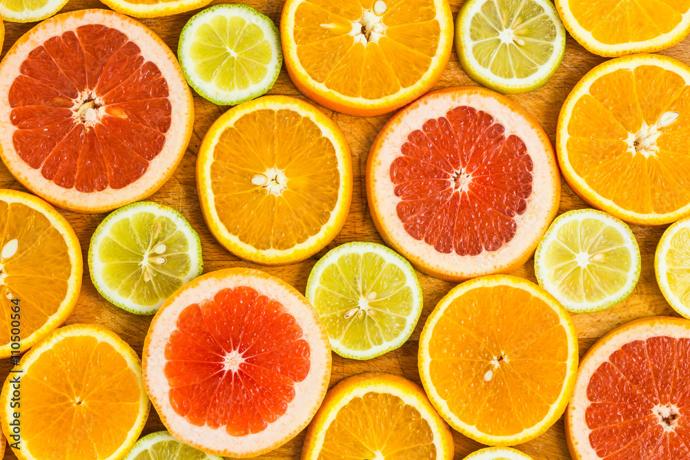 Citrus fruit background with sliced f oranges lemons lime tanger