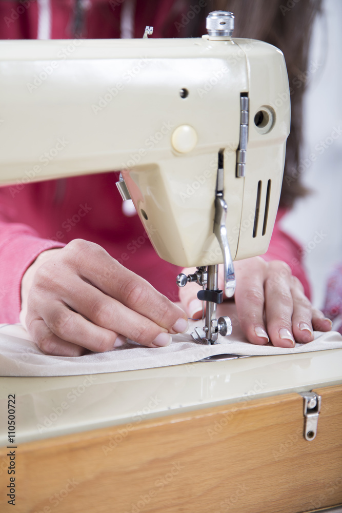 Sewing Process - Women's hands behind her sewing machine
