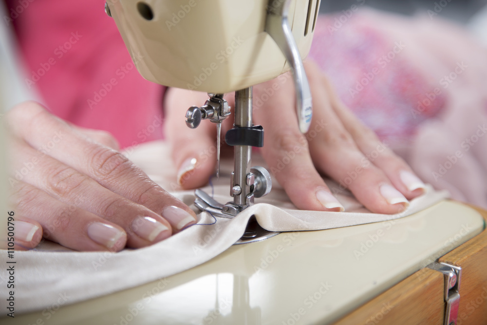 Sewing Process - Women's hands behind her sewing machine
