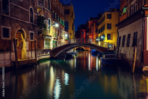 Venetian street in the night, bridge over canal, Italy
