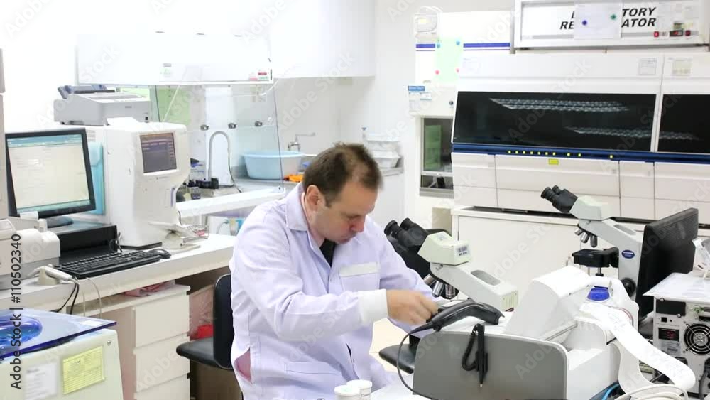 Rushing doctor in lab working with many devices in round. Scientific research with microscope in hospital. Busy scientist replace other workers in the laboratory Rushing doctor in lab working with many devices in round. Scientific research with microscope in hospital. Busy scientist replace other workers in the laboratory