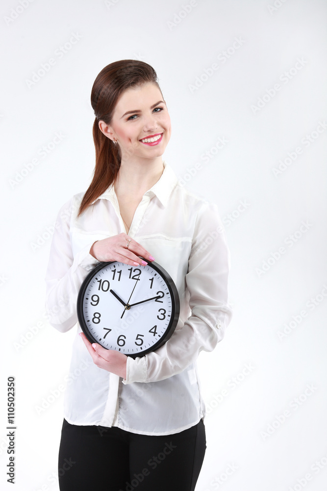 Smiling Business woman holding in hands clock, isolated on white Smiling Business woman holding in hands clock, isolated on white