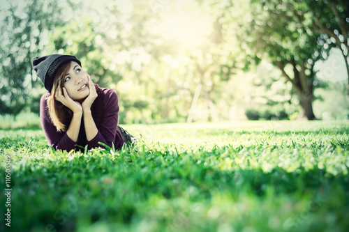beautiful woman thinking something on green grass