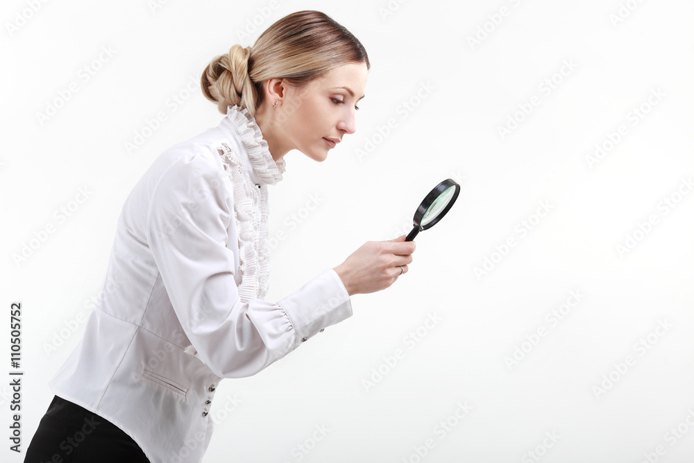 Young woman with a magnifying glass Young woman with a magnifying glass